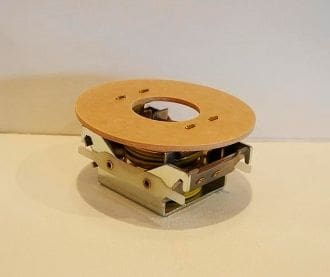 A small wooden disc is sitting on top of the table.