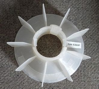 A white plastic fan with a label on it.