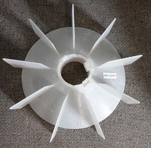 A white plastic fan on the floor.