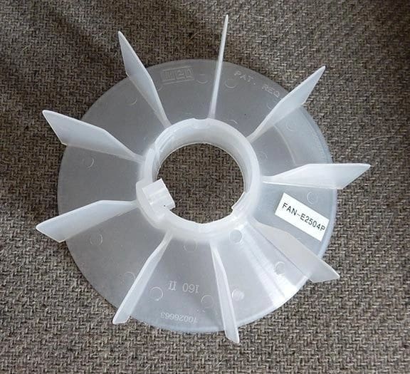 A plastic fan is sitting on the floor.